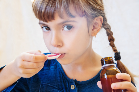 Sick child girl. Prescribe treatment. Selective focus Coldの写真素材