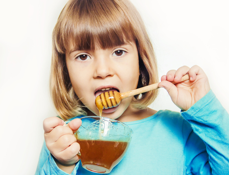 The child eats honey. Selective focus. nature foodの写真素材