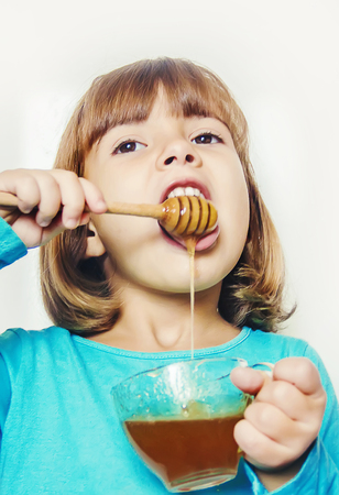 The child eats honey. Selective focus. nature foodの写真素材