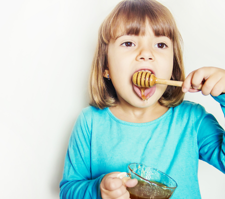 The child eats honey. Selective focus. nature foodの写真素材