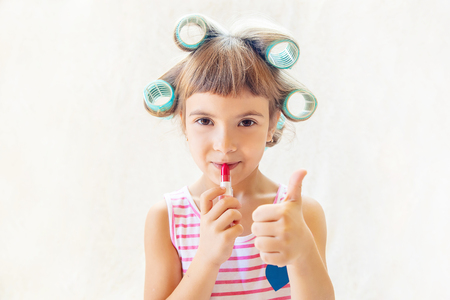 little fashion-girl. girl does her make up and manicure. selective focus. Children.の写真素材