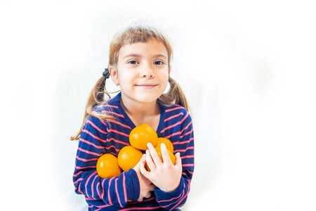 Child and tangerine. Selective focus. food and drink. natureの写真素材