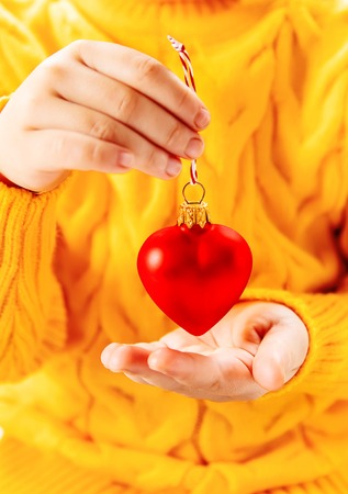 Child holds a Christmas decor and gifts on a white background. Selective focus. happy.の写真素材