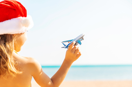 child with airplanes in hand on the beach. Selective focus. holidays.の写真素材
