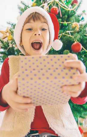 Child happy over christmas background. Christmas tree. Selective focus. Holidaysの写真素材