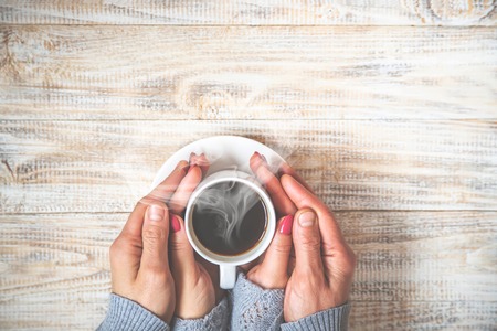 Cup drink for Breakfast in the hands of lovers. Selective focus. Nature.の写真素材