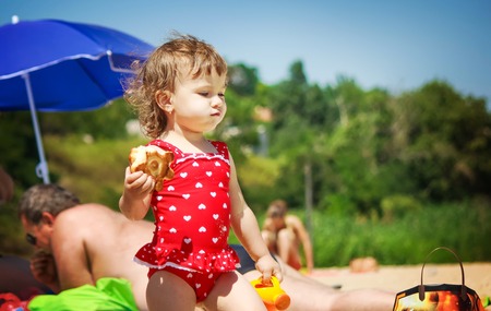 Baby girl on the beach, by the sea. Selective focus.の写真素材