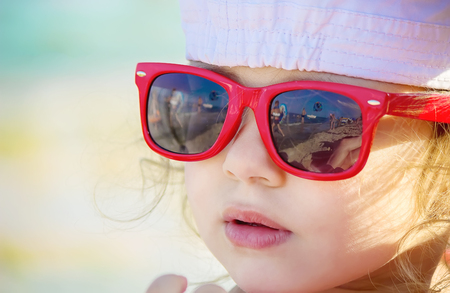 Baby girl on the beach, by the sea. Selective focus.の写真素材