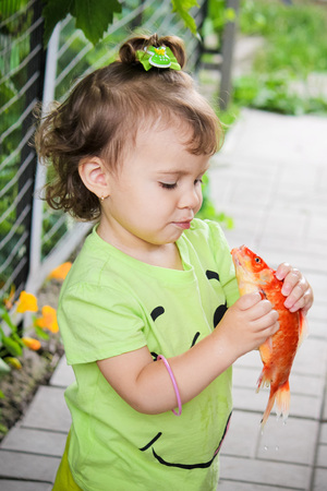 baby and red fish. Selective focus. nature.の写真素材