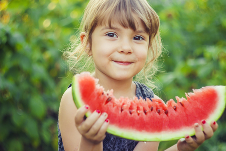 A child eats watermelon. Selective focus. nature.の写真素材