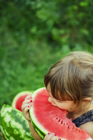 A child eats watermelon. Selective focus. nature.の写真素材