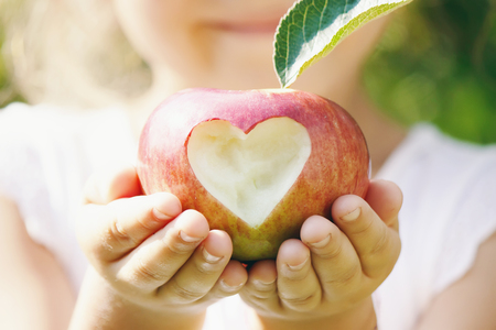 Child with Child with an apple. Selective focus. Garden Foodの写真素材