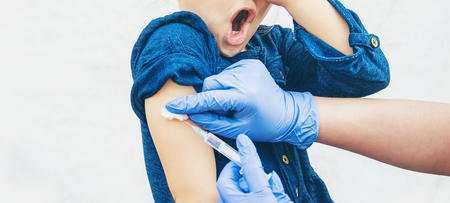 vaccination of children. An injection. Selective focus kids