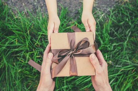 gift in the hands of a child. congratulations on his father's day. nature.