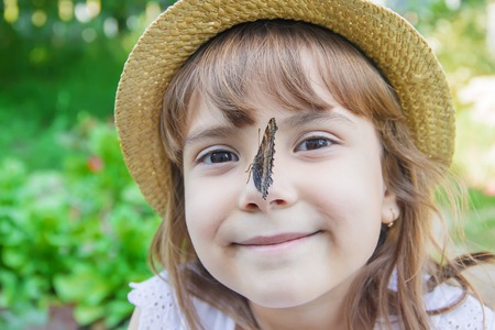 Child with a butterfly. Idea leuconoe. Selective focus.の写真素材