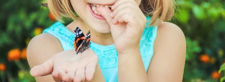 Child with a butterfly. Selective focus. nature and child.の写真素材