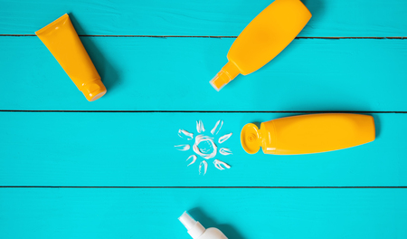 Sunscreen on a blue background. Selective focus. nature