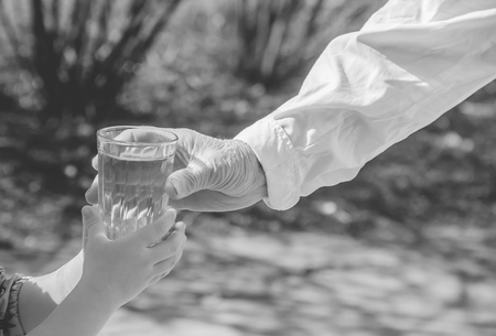Grandmother giving a glass of clean water to a child. Selective focus. nature.の写真素材