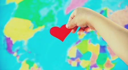 Child on the background of the world map. Likes to travel. Selective focus. nature.の写真素材