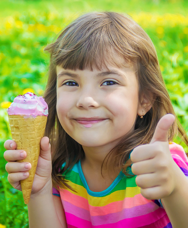 The child eats ice cream. Selective focus.の写真素材