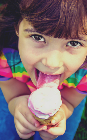 The child eats ice cream. Selective focus.の写真素材