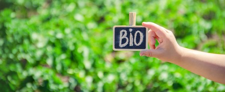 bio farm sign in the hands of a child. selective focus. nature.