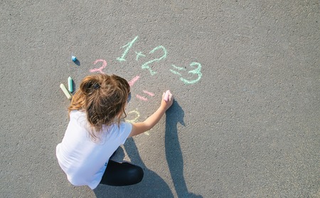 The child decides grunts on the asphalt. Selective focus. nature.の写真素材