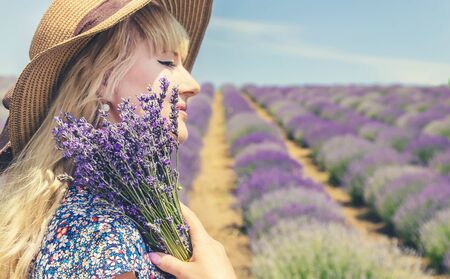 Girl in a flowering field of lavender. Selective focus. nature.の写真素材
