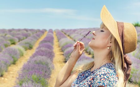 Girl in a flowering field of lavender. Selective focus. nature.の写真素材