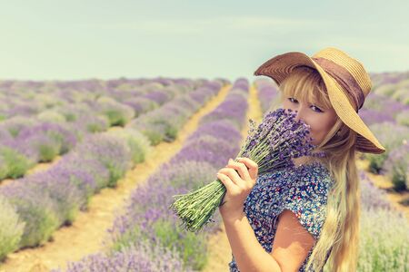 Girl in a flowering field of lavender. Selective focus. nature.の写真素材