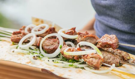 Georgian kebabs in the hands of men. Selective focus. nature.の写真素材