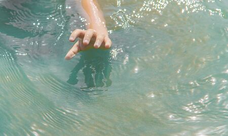 The baby is drowning in water. Selective focus.の写真素材