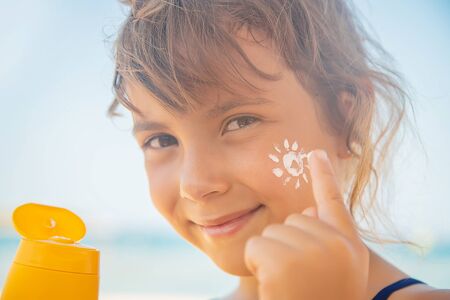 Sunscreen on the skin of a child. Selective focus.の写真素材