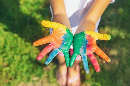 child with painted hands and legs. Selective focus. nature.の写真素材