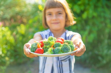 child eats vegetables broccoli and carrots. Selective focus.の写真素材