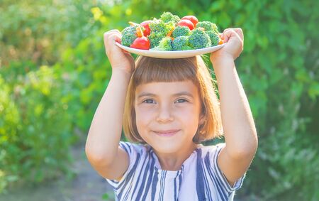 child eats vegetables broccoli and carrots. Selective focus.の写真素材