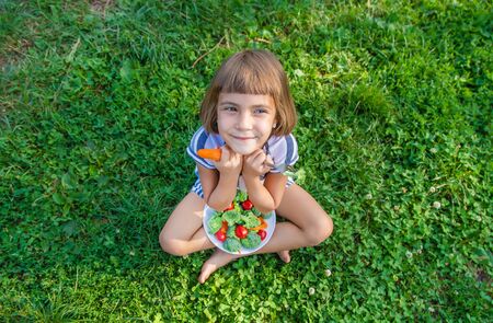 child eats vegetables broccoli and carrots. Selective focus.の写真素材