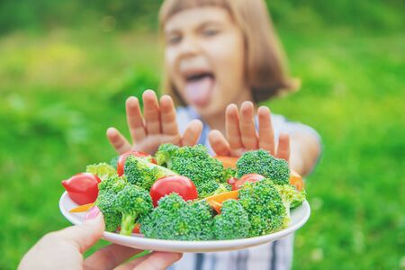 child eats vegetables broccoli and carrots. Selective focus.の写真素材