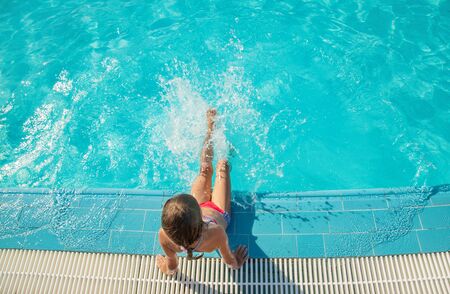 the child swims and dives in the pool. Selective focus. nature.