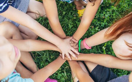 children's hands together on a background of grass. Selective focus. nature.の写真素材