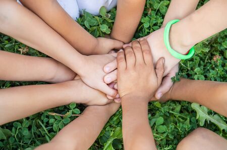 children's hands together on a background of grass. Selective focus. nature.