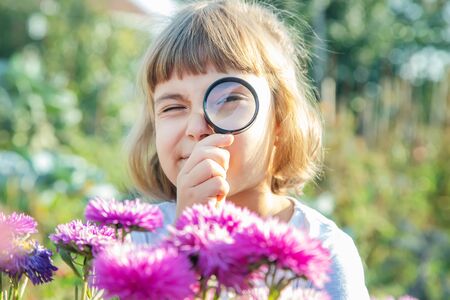 Child with a magnifying glass in his hands. Selective focus.の写真素材