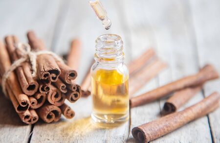 Cinnamon essential oil in a small bottle. Selective focus. nature.の写真素材