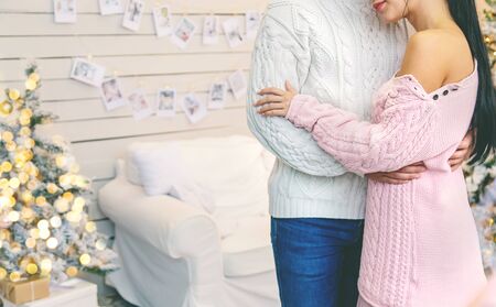 Christmas sparklers in the hands of a man and a woman. Holiday. Selective focus. People.の写真素材