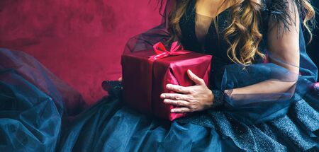 Girl with presents for the holiday. Selective focus. Red.の写真素材