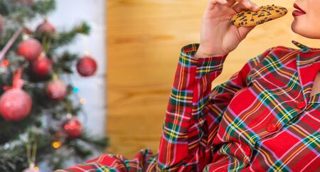 Christmas morning, the girl eats cookies. Selective focus. Holiday.の写真素材