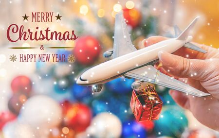 Beautiful christmas background with airplane. Travel concept for christmas and new year. Selective focus. Holiday.の写真素材