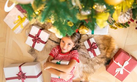 Children near the Christmas tree. Selective focus.の写真素材