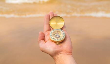 Compass on the background of the sea and the beach. Selective focus. travel.の写真素材