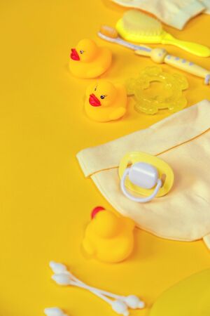 Accessories for bathing newborns on a yellow background. Selective focus. Baby.の写真素材